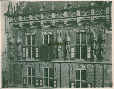 F001355 Beelden en laat-gotische ijzeren kooi aan de gevel van het Oude Raadhuis aan de Oudestraat, v.l.n.r. Karel de ...