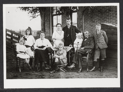FOTO-700601 Molenaar Vogelaar (zittend rechts) met echtgenote (zittend 2e van links) en kinderen voor het molenaarshuis ...