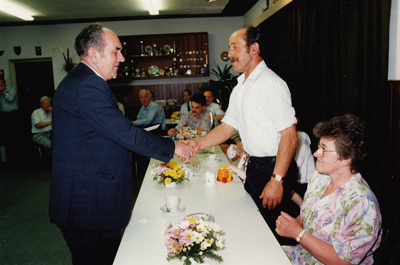 242462 Wethouder A. Reijnders feliciteert Sjef van Kasteren. rechts mevrouw van Kqsteren, 1990