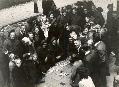 64838 Juliusstraat: chocolade, sigaretten en kauwgom. Britse soldaten krijgen hun rantsoenen uitgereikt onder grote ...