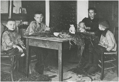193259 Het productieproces in de sigarenindustrie: het strippen of ontstelen van tabaksbladeren door thuiswerkers, ca. 1900