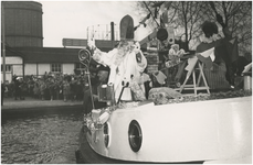 195396 Aankomst St. Nicolaas en Pieten: Havenhoofd, St. Nicolaas en Piet op de boot, op de achtergrond de gashouder, ...