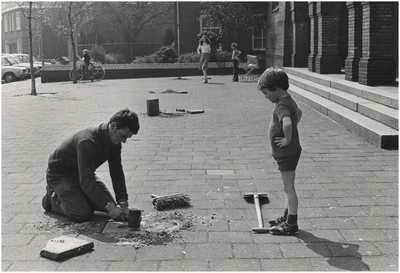 194556 Het aanleggen van een knikkerpot op een speelplaats door gemeentewerken, ca. 1980