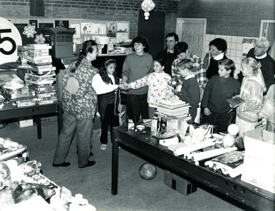 232039 Het aanbieden van verzamelde goederen aan de Stichting hulp voor Polen, door kinderen van de Paulusschool., 1991