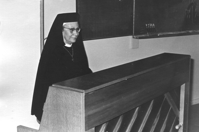152148 Zuster Marie Gerard oefent op de piano voor het afscheidsfeest van zuster Maria Regina van de kweekschool te Bergen