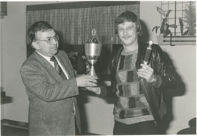 4457 - Prijsuitreiking van een voetbaltoernooi. Gerard Drenth (li. vz vv 't Harde) rijkt de prijs uit aan Gerrit Spaan.