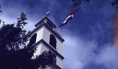 DIA39242 De vlag hangt uit de kerktoren vanwege Koninginnedag; ca. 30 april 1975