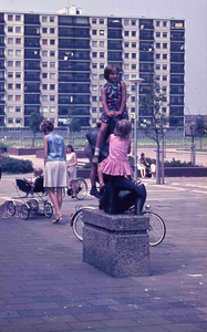 DIA42016 Kinderen spelen op het kunstwerk van Winkelcentrum 't Plateau. Op de achtergrond De Akeleiflat; 1973