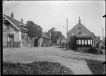 GN5110 Kijkje op een weg met enkele woningen in een onbekende locatie; ca. 1920