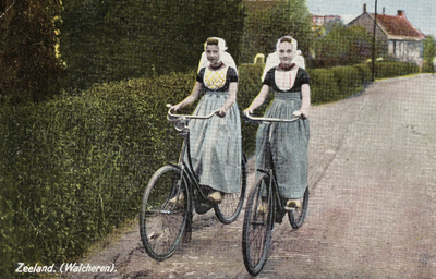 P-1241 Zeeland. (Walcheren).. Twee meisjes in Walcherse dracht op de fiets.