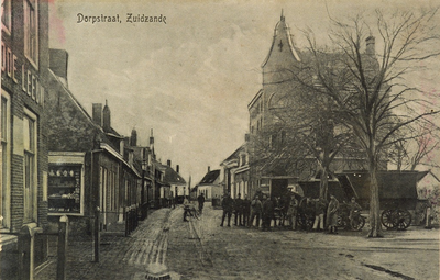 8694 Dorpstraat, Zuidzande. Gezicht op de Dorpsstraat en het Dorpsplein te Zuidzande met een aantal militairen, links ...