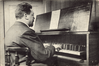 320-139 De carillonist Jan Morks in de Klavierkamer van den Abdijtoren te Middelburg, het klokkenspel bespelende. Jan ...