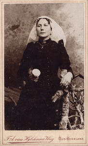 407-2 Nellie Bouwman-de Jong, in klederdracht met bloem in de hand, in fotostudio