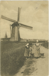 455-450 Drie meisjes in dracht, waarvan één met een juk, bij de molen te Domburg