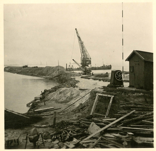 SW-2432 Ouwerkerk. Scheldesluis, dijkherstel aan de Zuidbout. Rechts de handlier en het botenhuis van de peilboot.