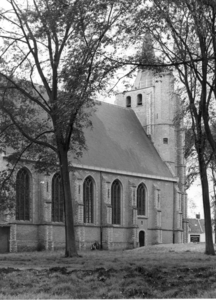 W-0058 Renesse. De Ned. Herv. Jacobuskerk, nog tussen de oude iepen. Rechts een zandhoop i.v.m. opgravingen bij de kerk.