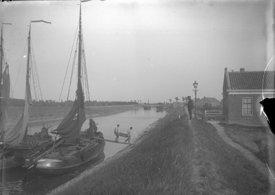 O-0593 Brouwershaven. Garnalen lossen bij de pellerij van Kees Janse. Op de plank lopen Kees van Noord (rechts) en ...