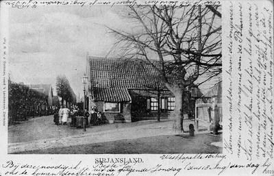 BE-1615 Sirjansland. Dorpsstraat. Voormalige bakkerij annex café. Rechts de travalje van de smederij.