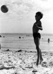 178 NFR Een kind speelt met een bal op het strand bij Westkapelle.