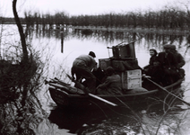510 NFR Mensen met huisraad in een bootje tijdens inundatie ter hoogte van Oostkapelle.