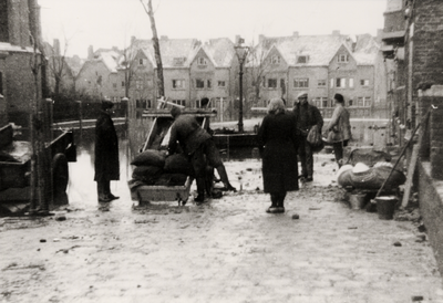 1348 Tweede Wereldoorlog. Na de inundatie halen burgers huisraad uit de ondergelopen huizen in de Brouwenaarstraat