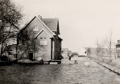 24189 Tweede Wereldoorlog. De Paul Krugerstraat tijdens de inundatie. Rechts ziet men de nooddijk