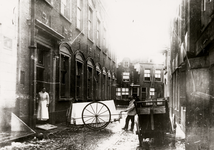 25677 Het Gasthuis in de Hellebardierstraat, met zuster Sipma in de deuropening. Achter de ziekenkar: Jan Sorel. Men ...