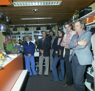 47385 Groepsfoto bij de heropening van de radio-, tv- en fotozaak van de fa. Dert, Nieuwendijk 35 en Nieuwendijk 37 na ...