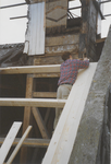 0690-3963 Timmerman bezig met nieuw dakbeschot tijdens de restauratie van de kerk.