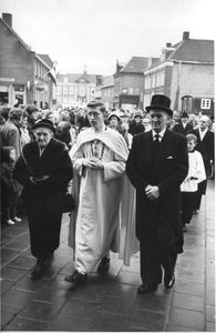 140548 Pater Harrie van de Ven met zijn ouders op weg naar de kerk voor zijn priesterwijding te Veghel