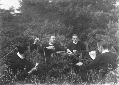 186559 Studenten van de Nebo aan het kaarten in de open lucht
