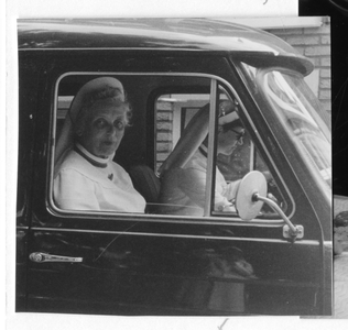 102046 Zuster Angela en zuster Henriette met de wagen op huisbezoek