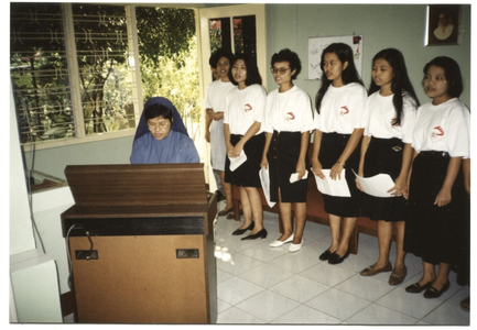 246057 Koor van de verpleegstersopleiding met zuster Corona aan het orgel te Abinong, Java, Indonesië