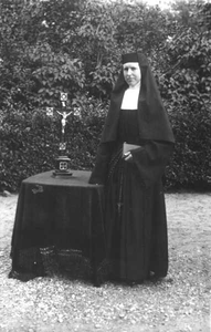152267 Statieportret van zuster Kunegondis in de kloostertuin van Warmerhuizen