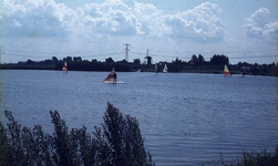 DIA00035 Surfers op de Bernisse (met de molen van Abbenbroek aan de horizon, evenals een hoogspanningsmast); ca. 1985