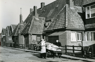 196 - Oude Urker huisjes met de groenteman en een vrouw en kind in klederdracht
