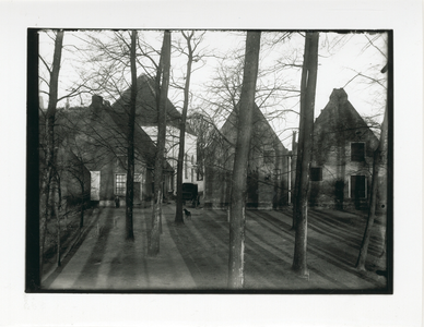 1579 - Woningen achter een aantal bomen