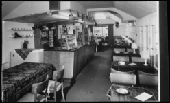 235 - interieur van restaurant, met rechts tafel en stoelen, links, in het midden, een bar