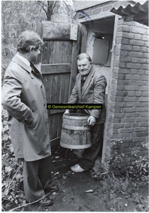 F006995 De laatste ton wordt gelicht uit het buiten toilet aan de Reijersdijk door ambtenaar Jan Schreurs.