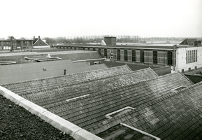 F009595 Diverse gebouwen, waaronder het magazijn en kantoor, op de voorgrond het dak van een afdeling dat toebehoort ...