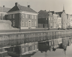 F000427 De Burgwal en de stadsgracht de Burgel, links de muur van de R.K. pastorie, de voorgevel met torentje rechts is ...