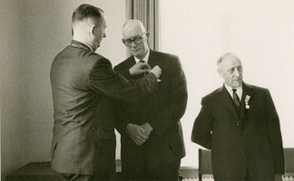 F011651 IJsselmuiden, de Koningklijke onderscheiding aan de hr. H.J. Held (midden) en H.J. Boom (rechts) wordt door ...