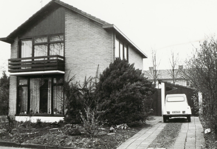  De vrijstaande woning met rechts ervan de oprit met een 'lelijke eend' (Citroën 2CV) met kenteken 12-18-PA.