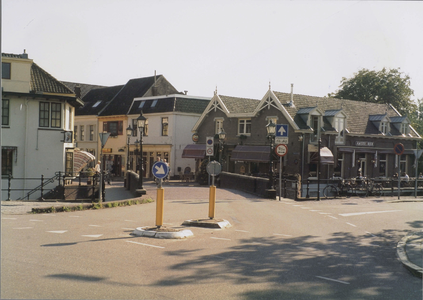  Gezicht over de brug op terras en café.