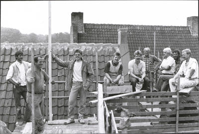  Enkele bouwvakkers op het dak tijdens de restauratie van het woonhuis.