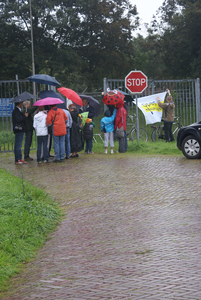  Open Monumentendag: bezoekers bij de ingang van Fort Honswijk. Sander van Scherpenzeel hangt een spandoek op