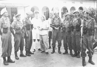 Nurse T. Jongsma and lieutenant A. Hengeveld of the Royal Navy with members of the Sikh Brigade in front of the entrance of the cloister-turned-hospital Mater Dolorosa in Batavia, 1945.&lt;br/&gt;NIOD 48871 &lt;a class=uline href=http://www.beeldbankwo2.nl target=_blank&gt;Beeldbank WO2&lt;/a&gt;